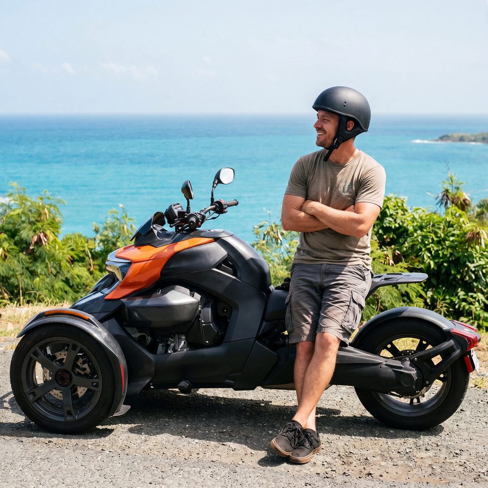 Smiling rider beside a Super Trike at a St. Thomas overlook
