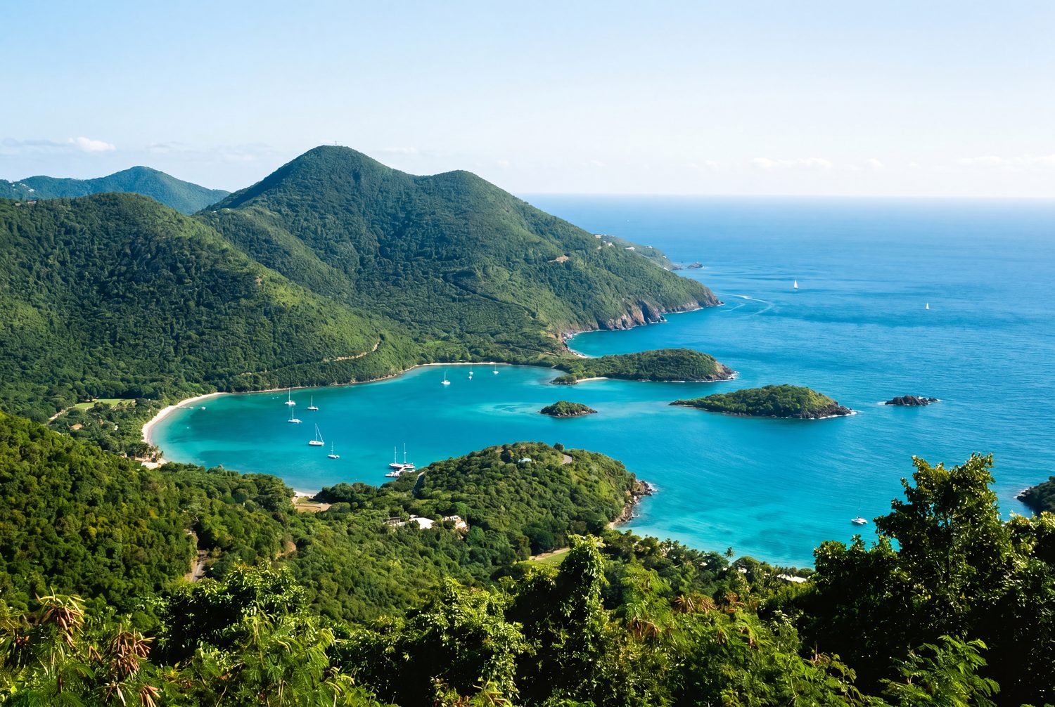 Lush green peaks meeting turquoise water at Mountain Top